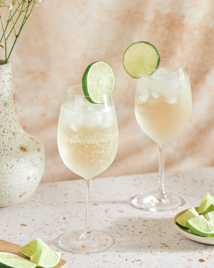 Two wine spritzers with lime