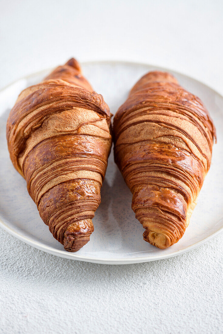 Two croissants on a white plate
