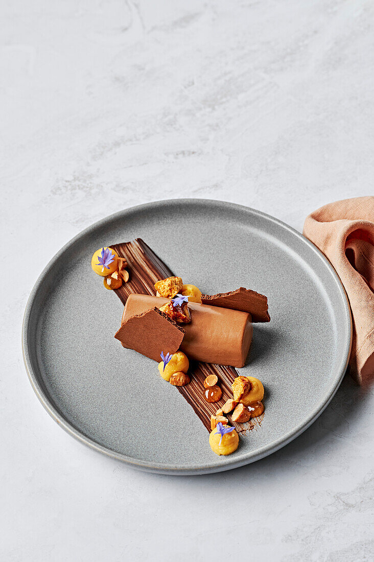 Chocolate mousse with mandarin curd, toasted hazelnuts, honeycomb, and mandarin gel