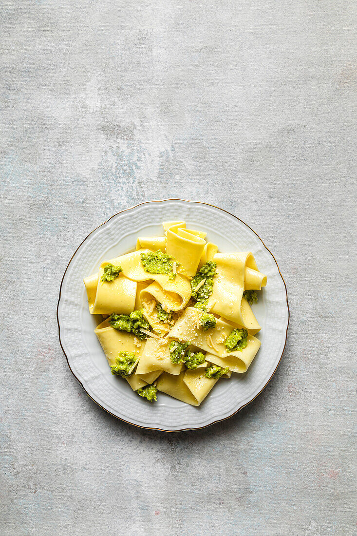 Plate of appardelle with pesto on the table