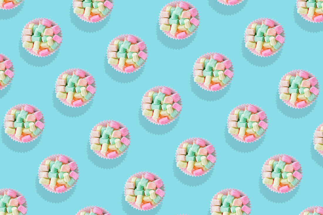 Modern retro color theme pattern of pastel candies against an aqua blue background.