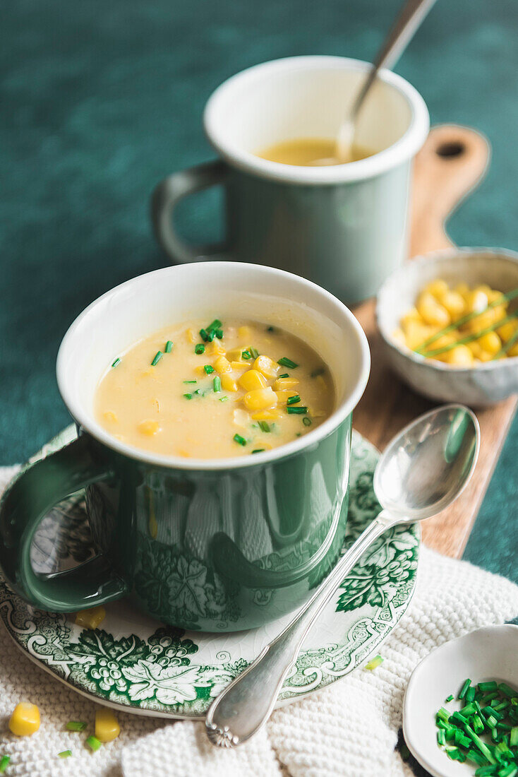 Corn chowder in a green mug with sweetcorn