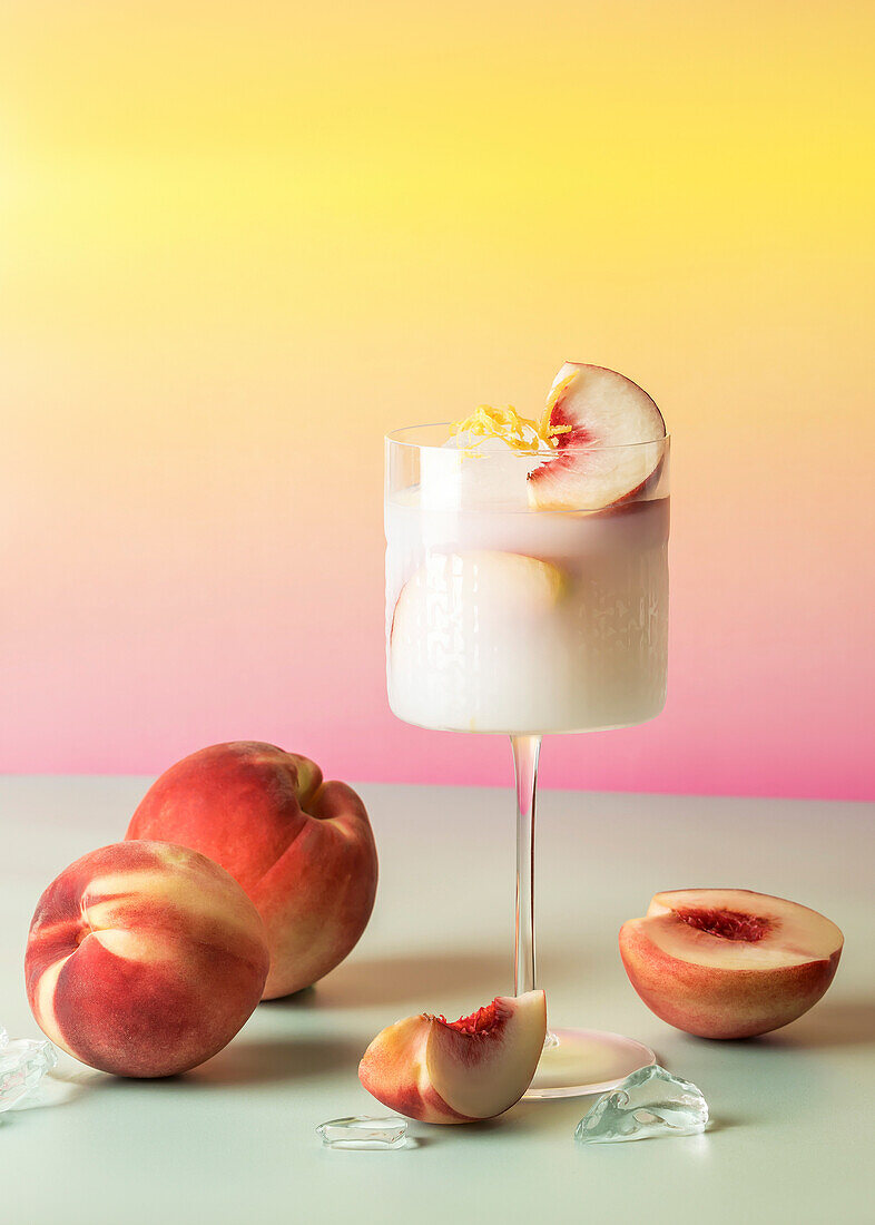 White peach cocktail with fresh peaches