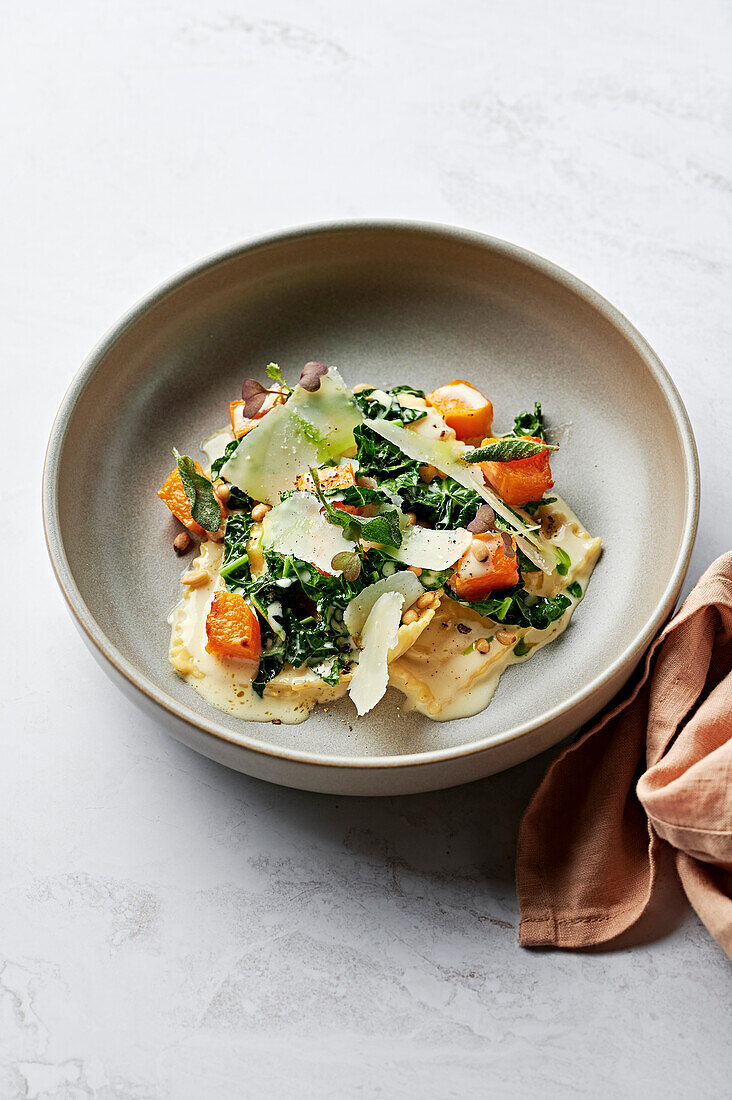 Roasted pumpkin and parmesan ravioli, cavolo nero, roasted butternut squash, sage cream sauce, toasted pine nuts and shaved parmesan cheese