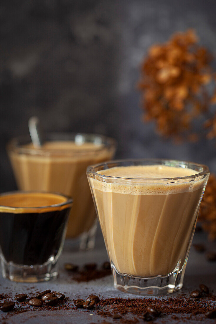 Glasses of Spanish Latte (caffe con leche) with a shot of espresso in a smaller glass.