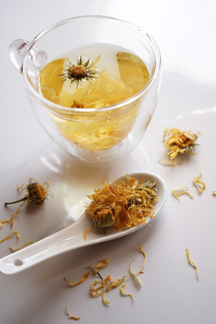 Calendula dried marigold medicinal tea with dried flowers closeup.