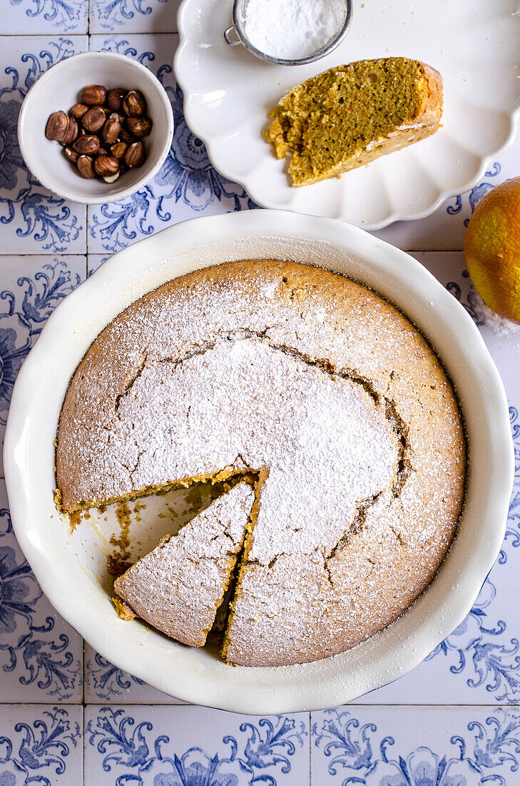 Carrot and hazelnut cake on blue tiles