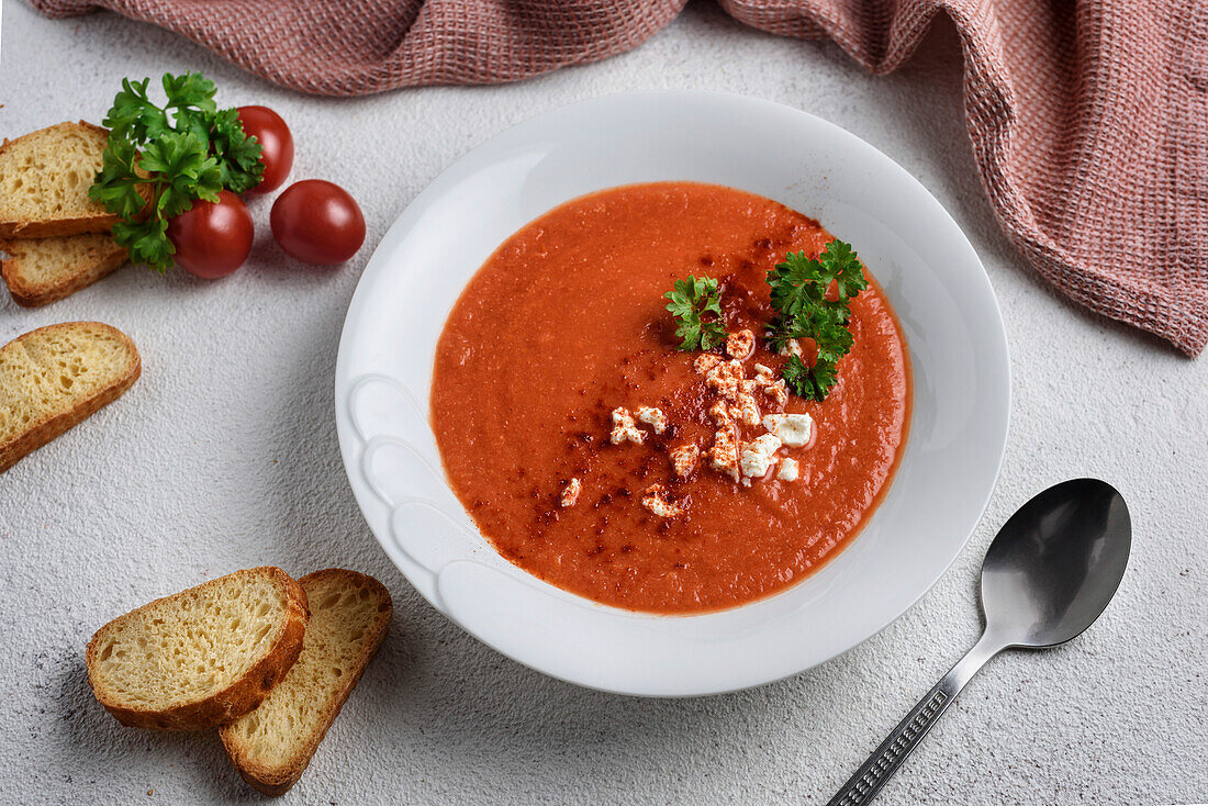 Cream of tomato soup, decorated with cheese and parsley. View from above