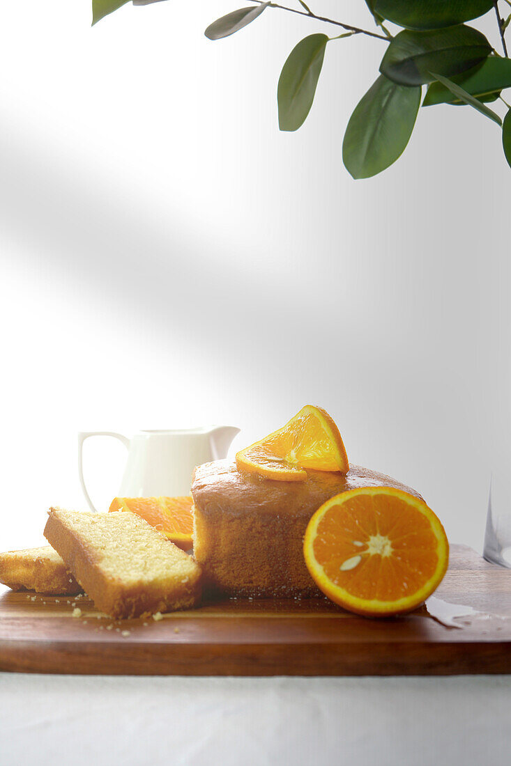 Orange Madeira cake with syrup and fresh orange slices and syrup, close-up