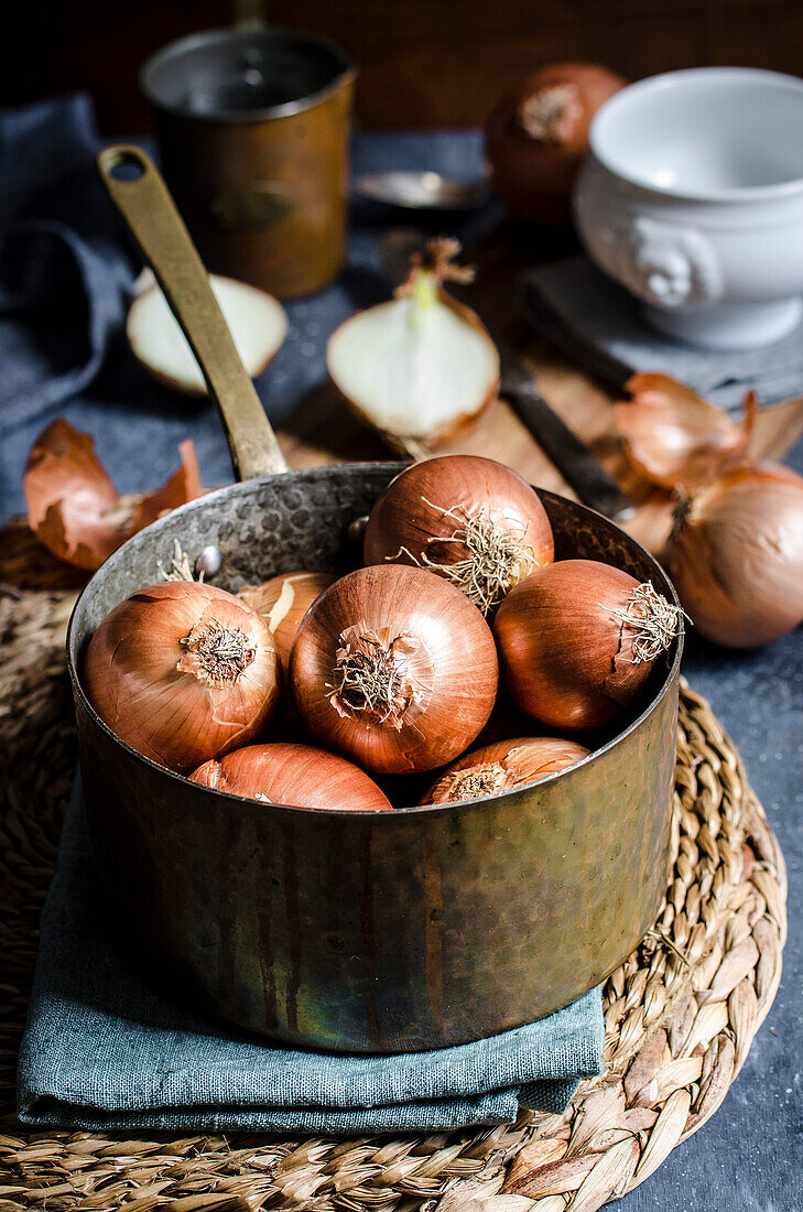 The making of onion soup in a rustic kitchen