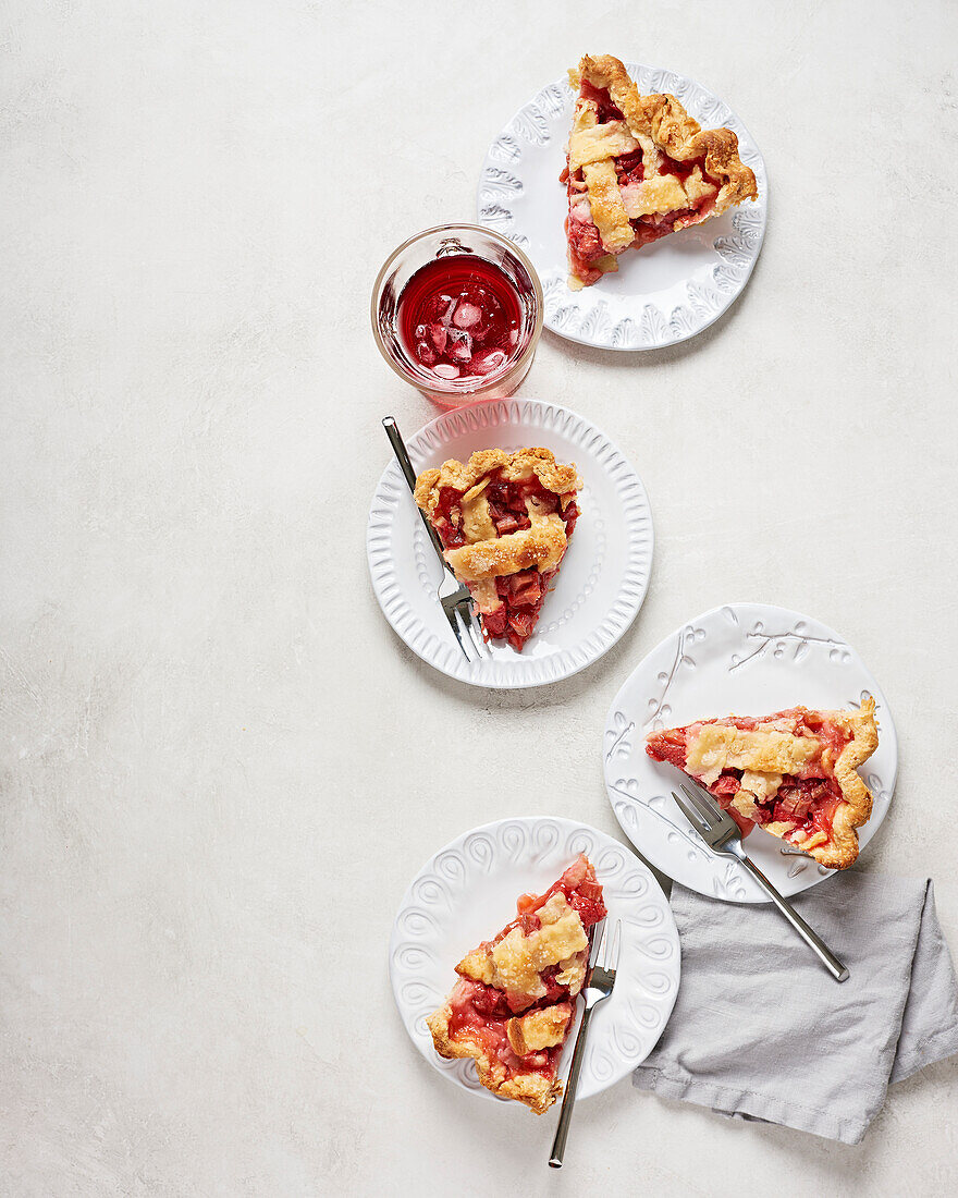 Vegan strawberry and rhubarb cake in slices on a white plate