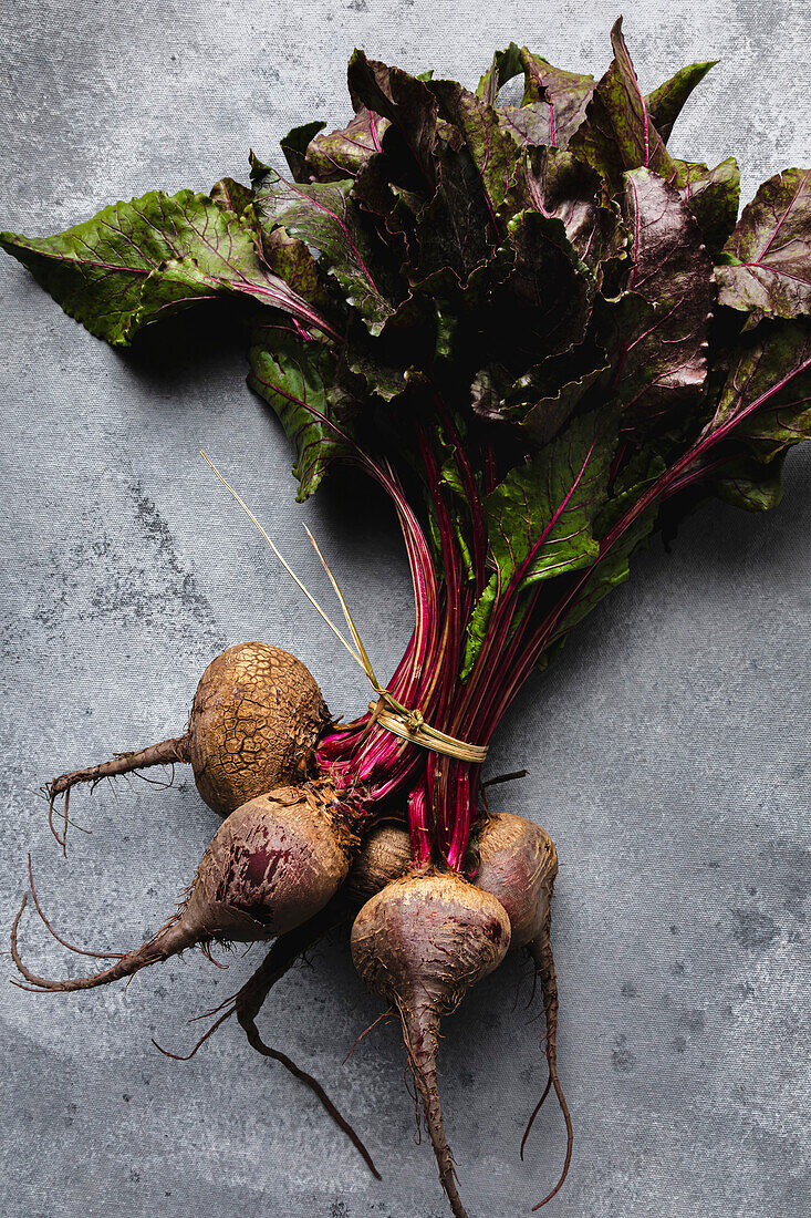Bundle of beetroot against a grey background