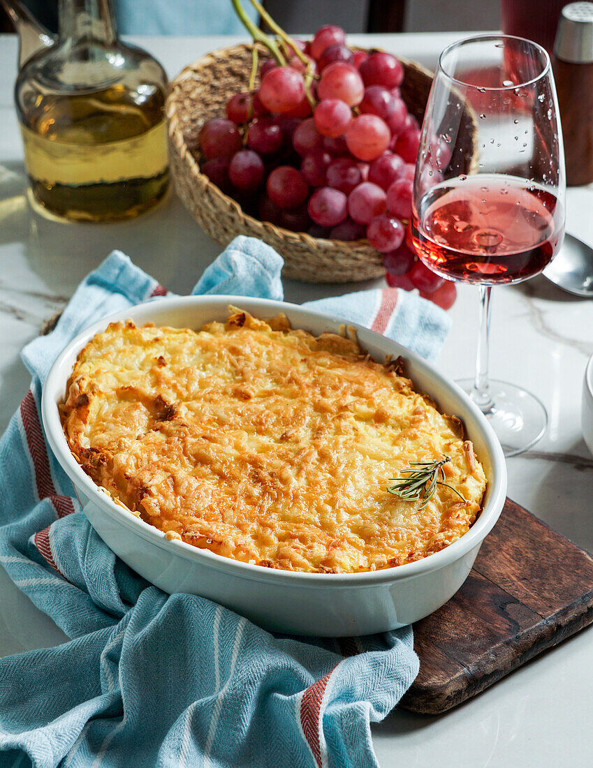 Shepherd's pie or cottage pie is a casserole with a layer of cooked meat and vegetables, topped with mashed potatoes