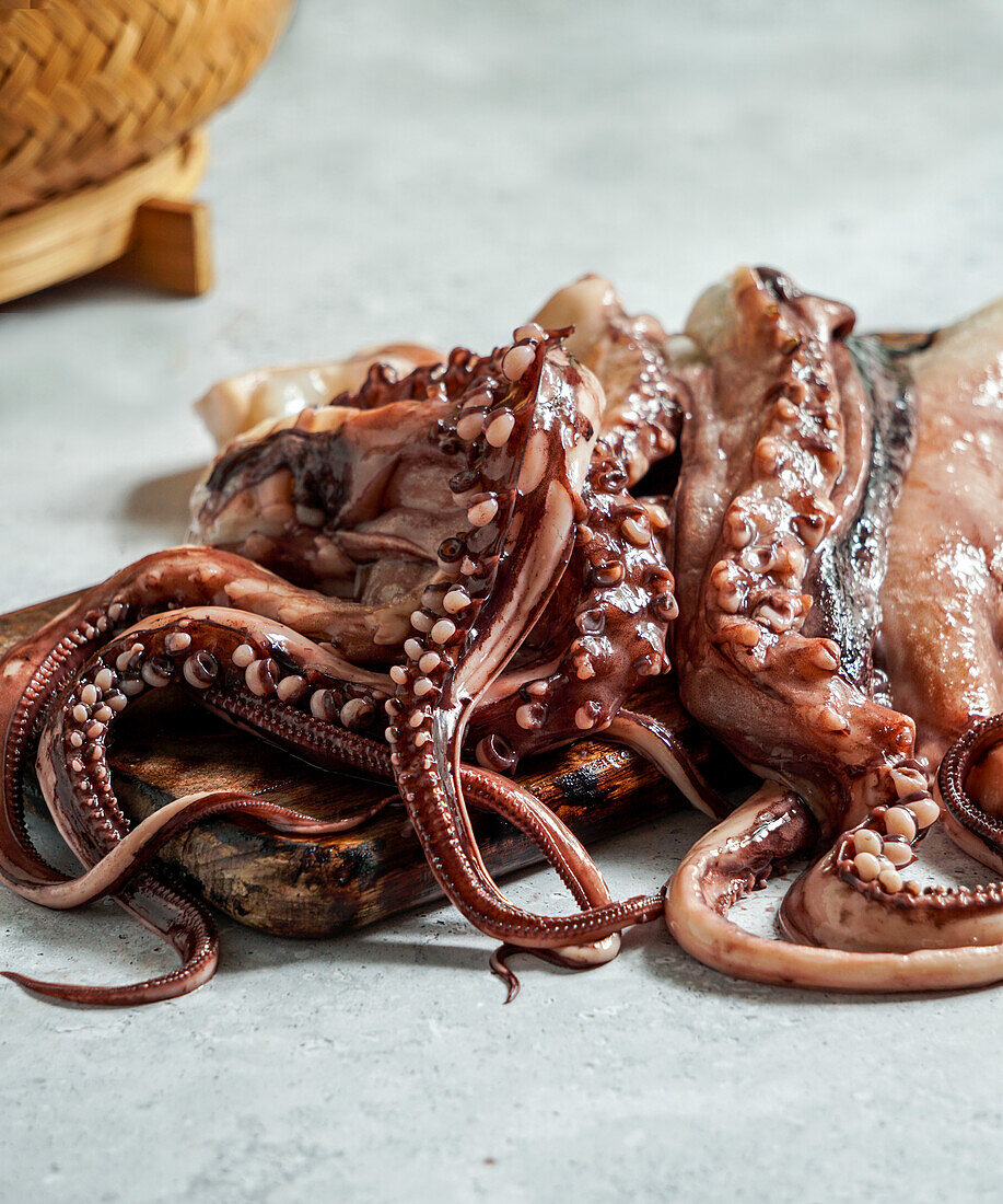Raw octopus tentacles in a kitchen