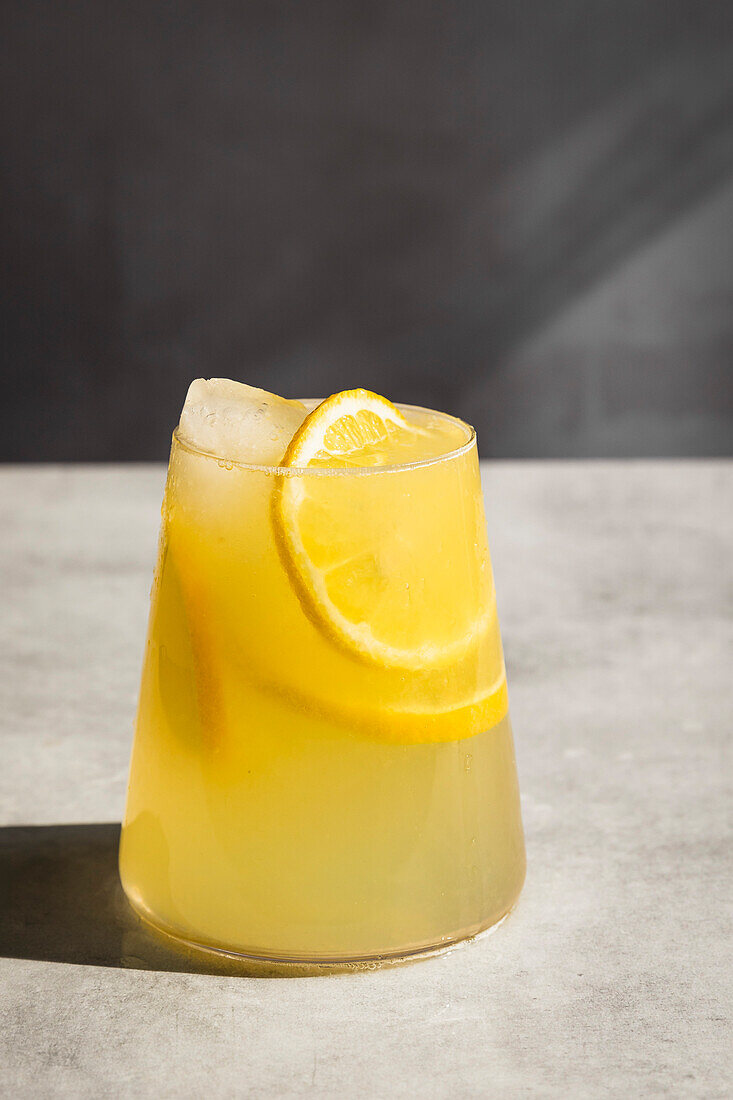 Homemade lemonade with ice and lemon slices in a glass