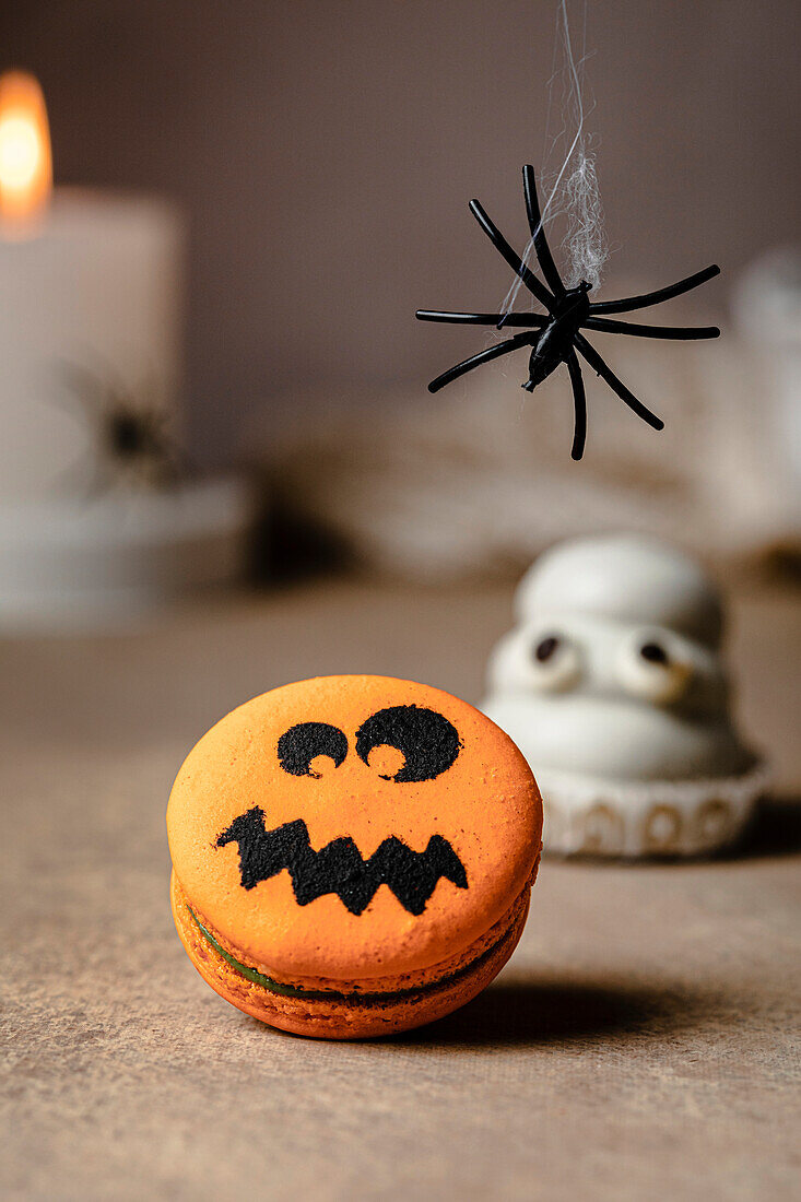 Jack-o-Lantern macaron over table for Halloween