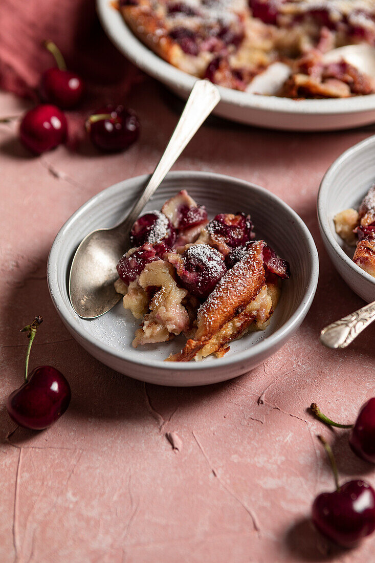 Cherry clafoutis on a pink background