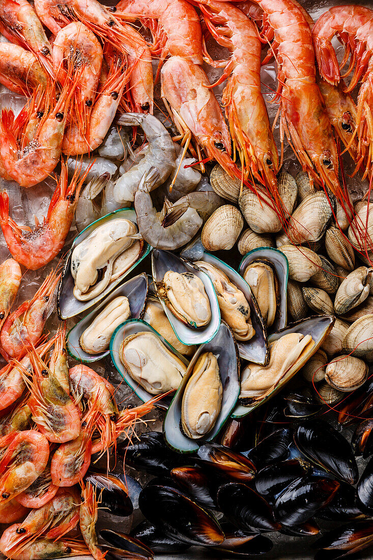 Raw fresh seafood cocktail with mussels, clams, vongole, prawns and crab close-up