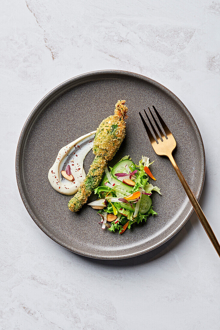 Stuffed courgette flower, tahini labna, cucumber and radish salad