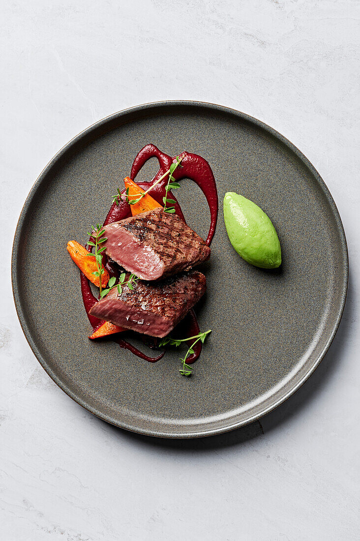 Grilled rack of lamb, herb puree, beetroot puree, honey-glazed carrots, aubergine and grape agrodolce