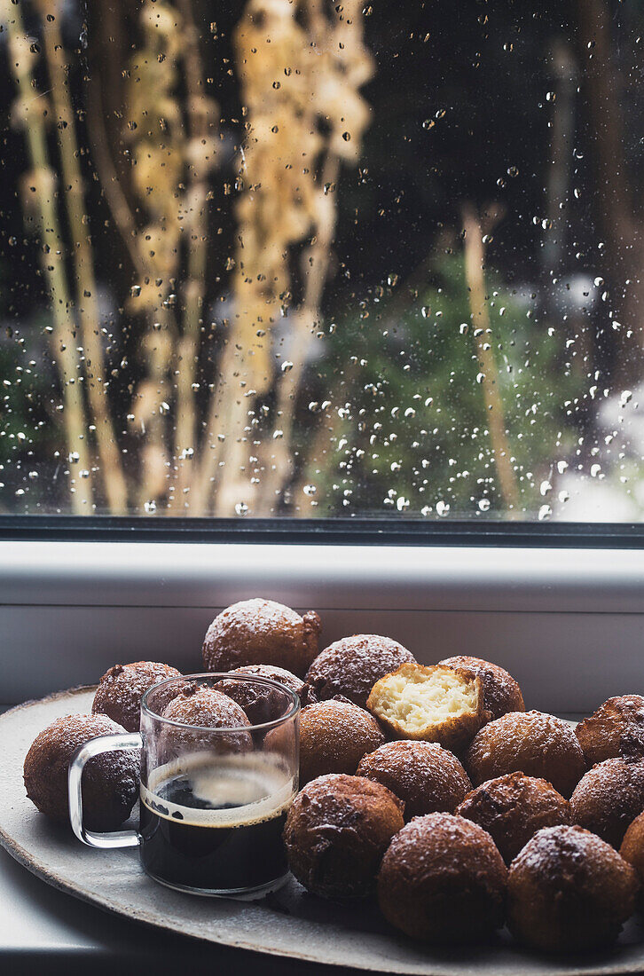 Ricotta cakes on a plate by the window