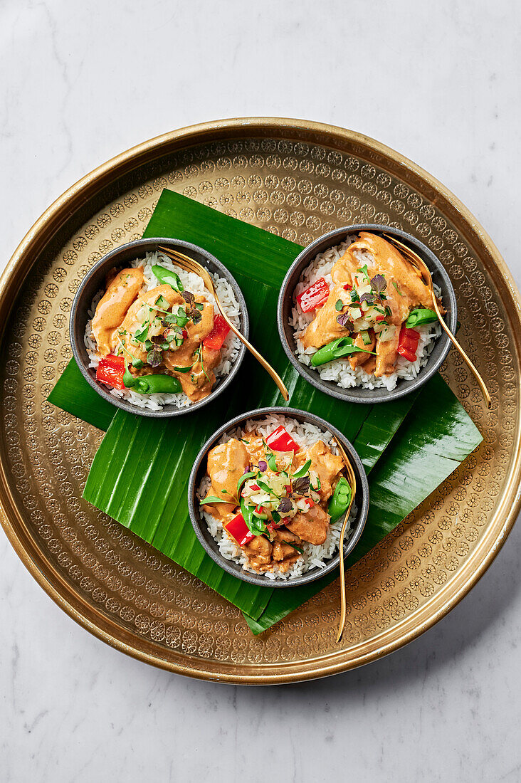 Malaysian-style red chicken curry with pineapple and kaffir lime salsa on steamed rice