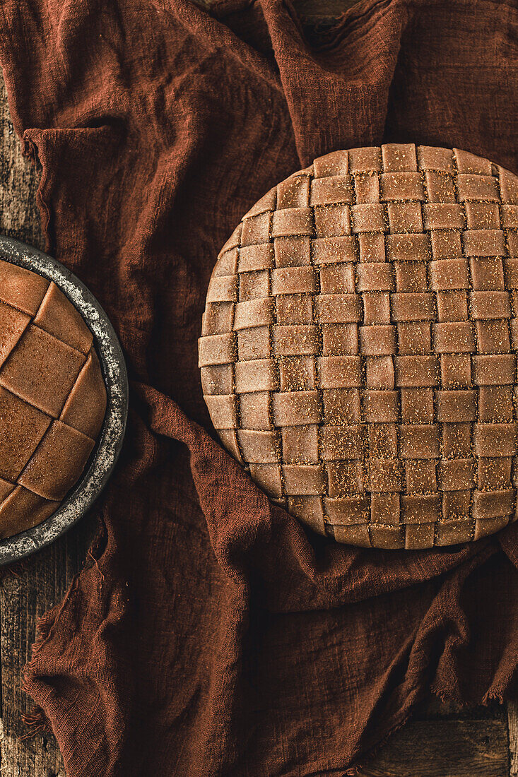 Vegan apple pie in lattice form, with copy template against a brown background