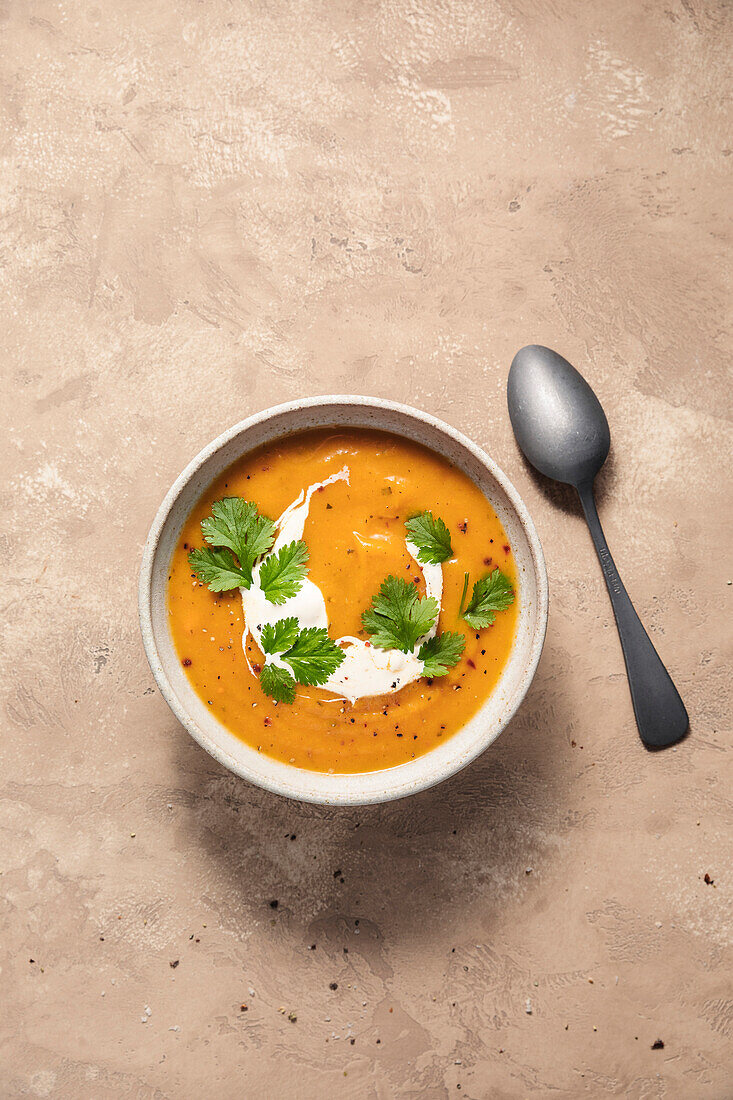 Butternut squash soup with spoon.