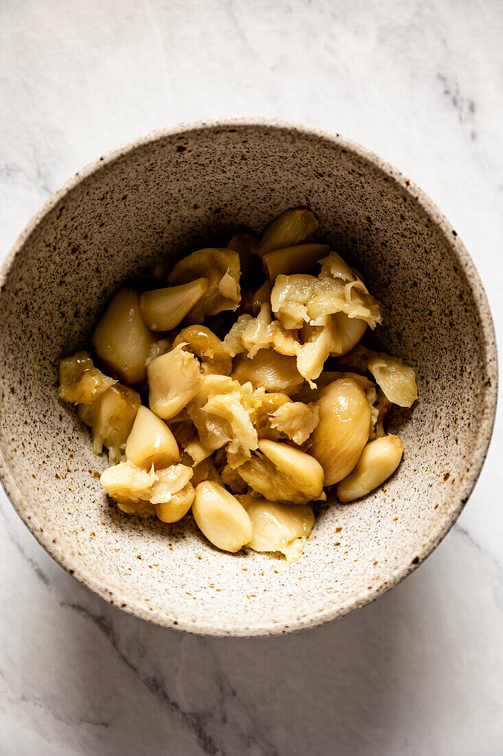 Home baked garlic cloves in a bowl