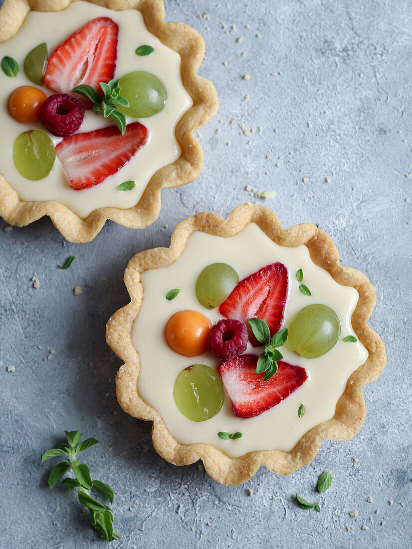 Fresh fruit and custard cream cake decorated with mint leaves