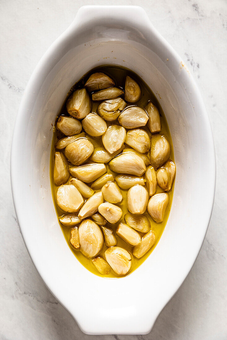 Home baked garlic cloves in a bowl