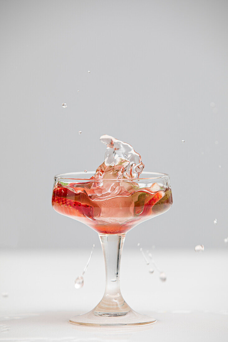 A splash in a cocktail glass with blanks