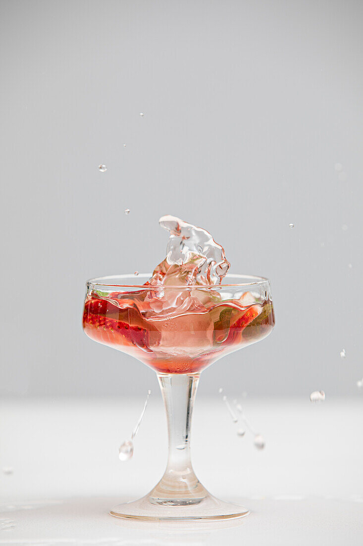 A splash in a cocktail glass with copy space