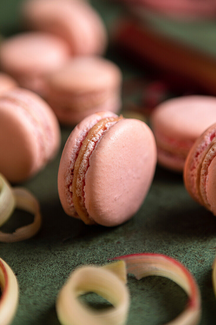 Rhubarb macarons on a green background