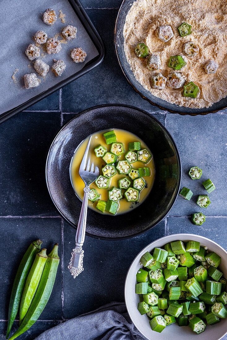 Okra slices are dipped in beaten eggs and then rolled in cornflour