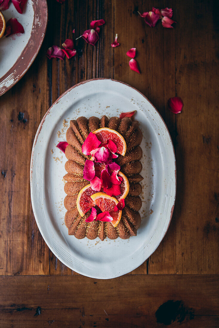 Blood orange cake on a plate in front of a wooden table