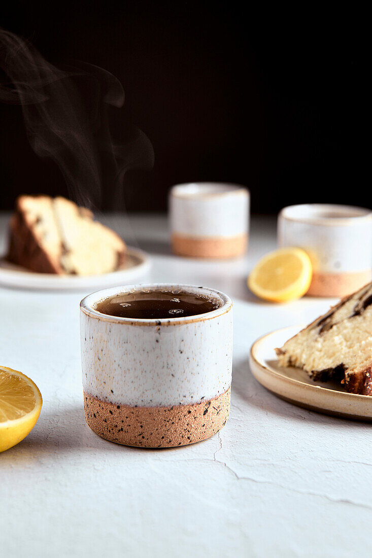 Black tea with lemon in small ceramic cups