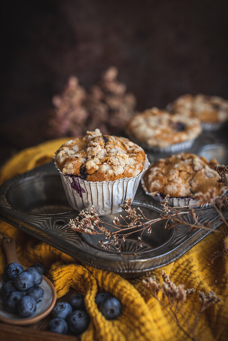 Pumpkin and blueberry muffins in a baking tray