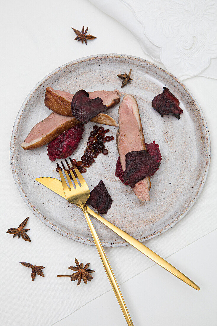 Duck balsamic pearls with beetroot puree and beetroot crisps