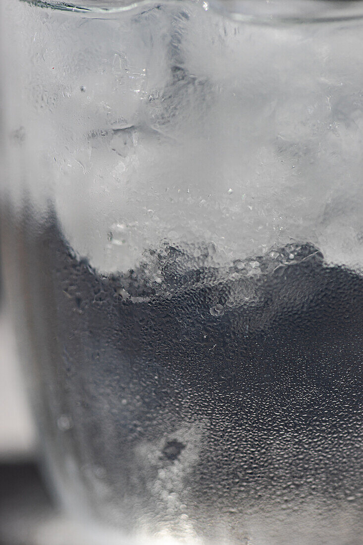 Close-up of a glass of pure water with ice cubes on a hot summer's day