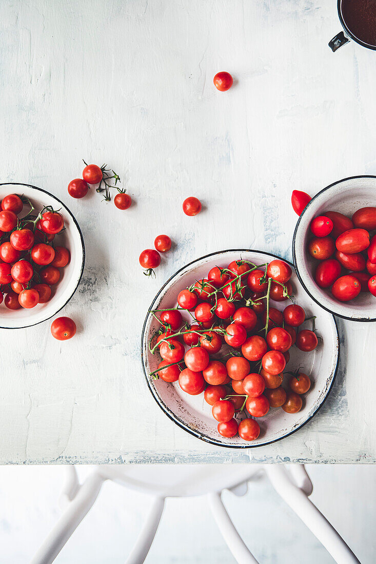 Tomatoes on a vine on a table with a copy surface