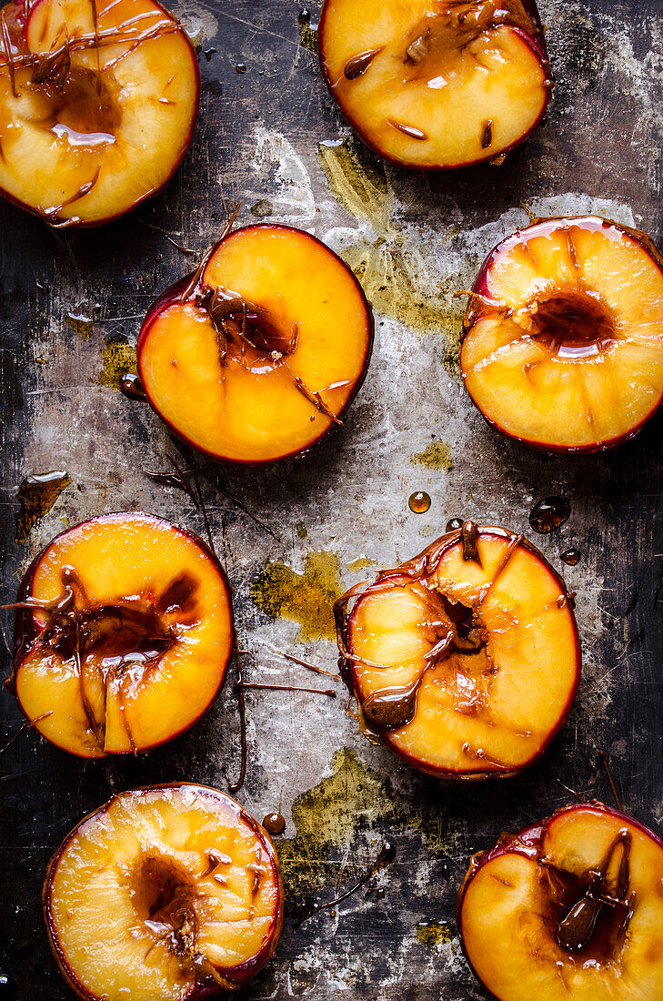 Caramelised plums on a baking tray