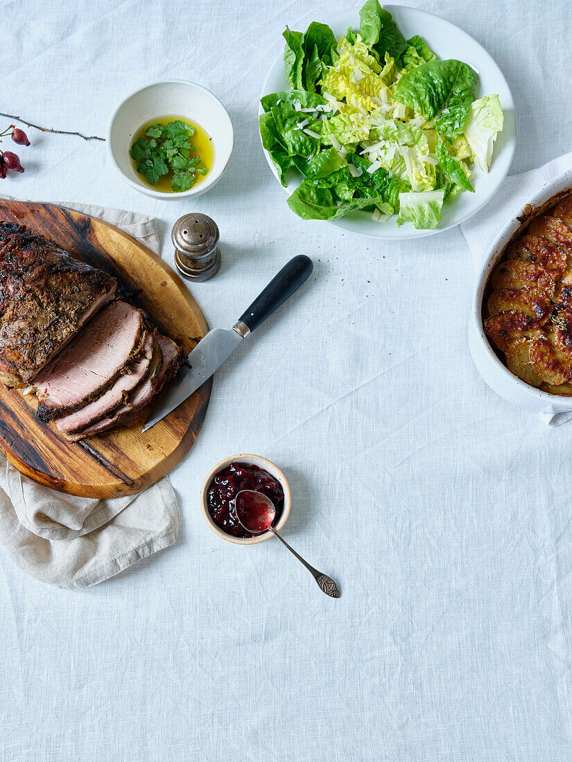 Dinner with slow roasted pork, potatoes and salad. Flatlay with copy area