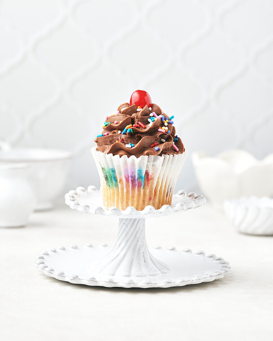 Vegan and gluten-free funfetti cupcake with chocolate funfetti icing