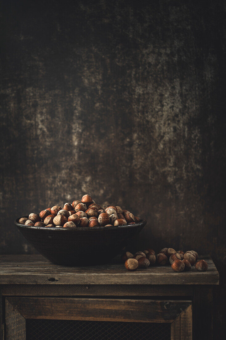 Hazelnuts in a bowl with copy space