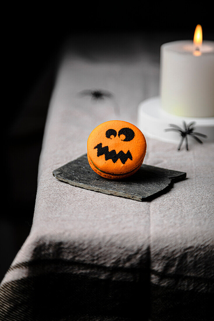 Jack-o-Lantern macaron over the table for Halloween