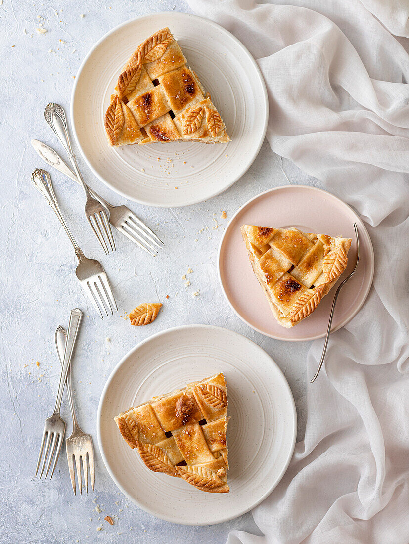 Apple pie slices on plates with forks