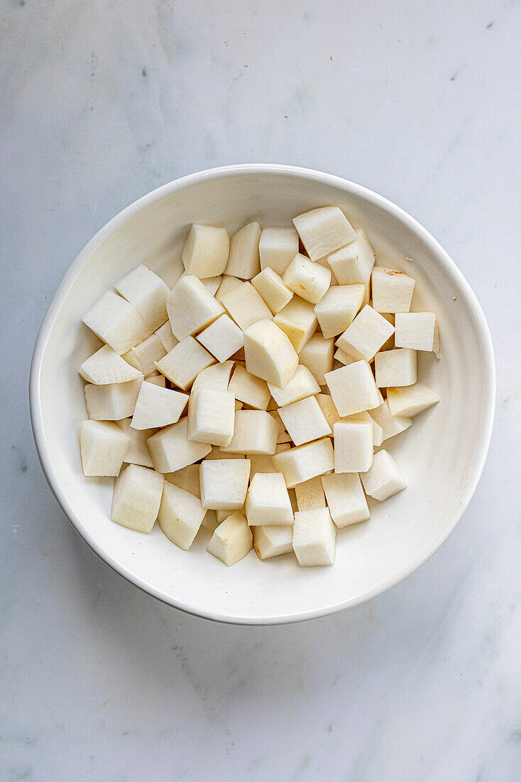 Turnip cubes in a white bowl
