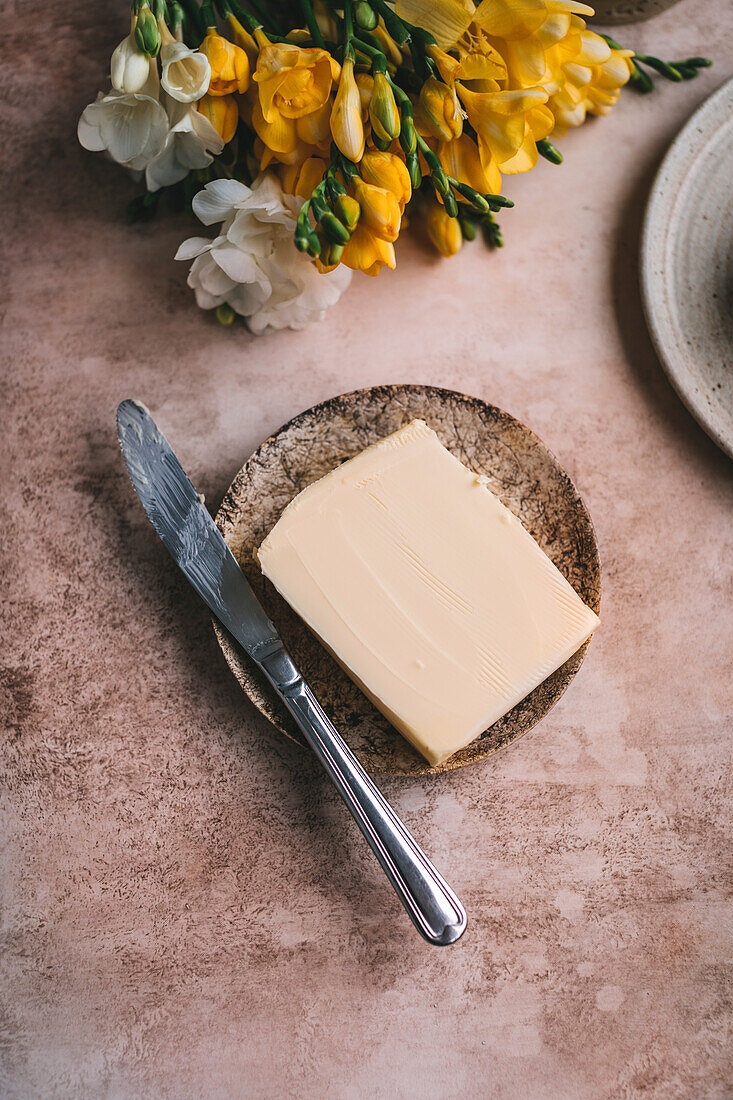 Butter served on a small ceramic plate