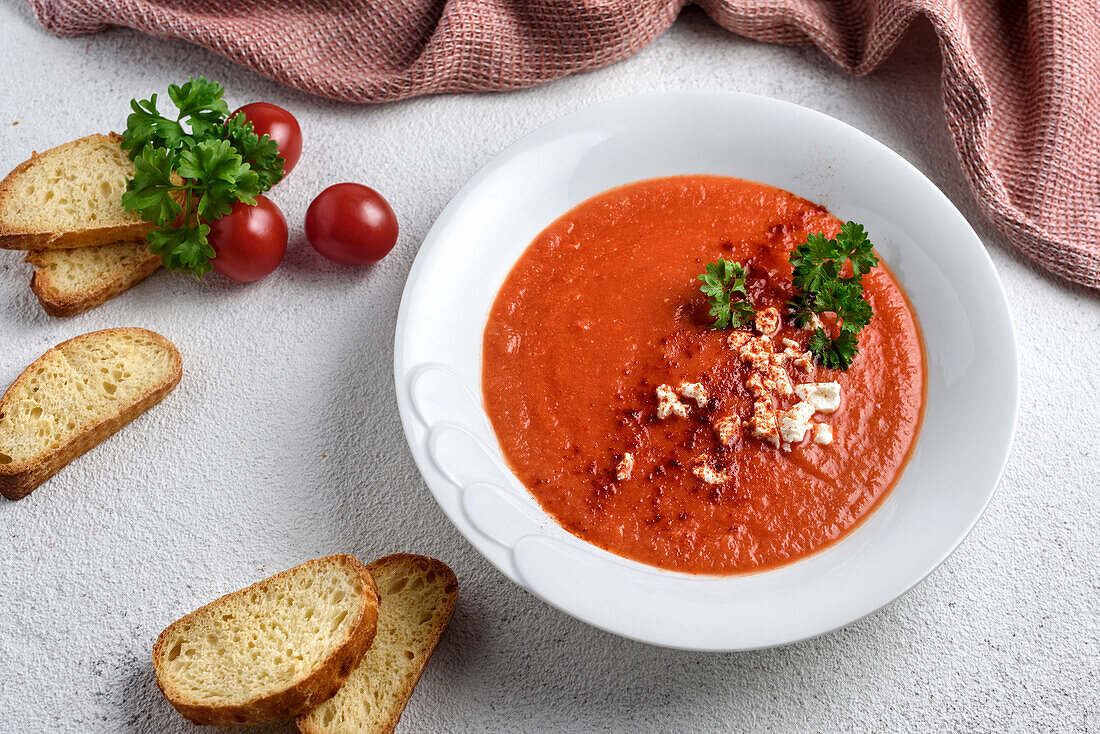 Cream of tomato soup, decorated with cheese and parsley. View from above